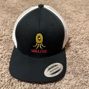 Black and White Snapback Trucker Cap with Gold and Red Shelter Logo